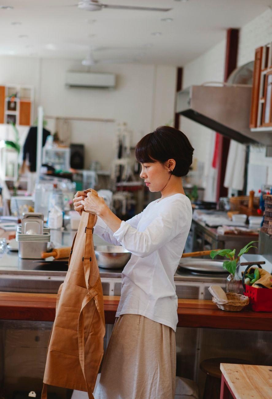 A woman shopping at a small grocery counter