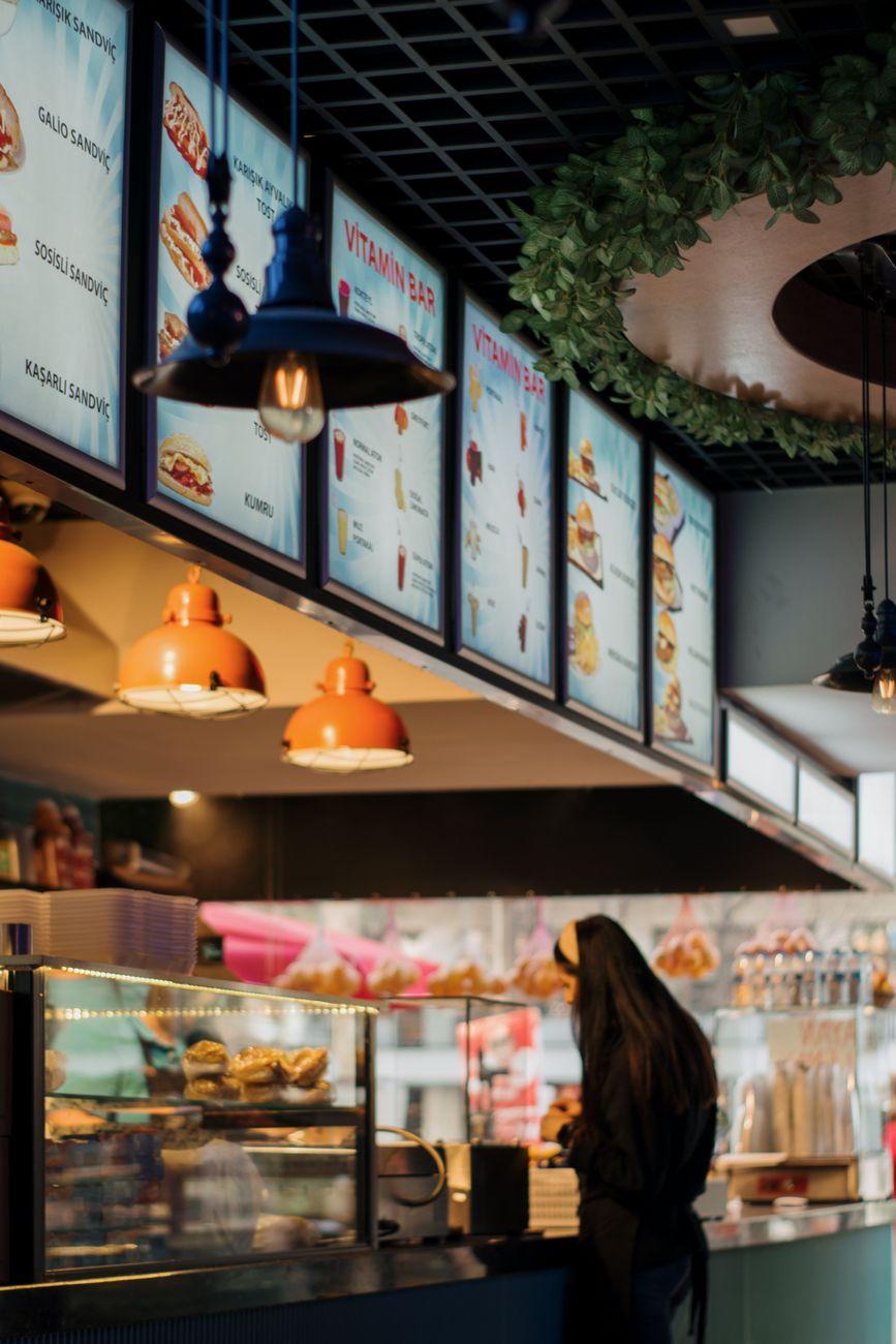 A busy food-stall counter with staff serving customers
